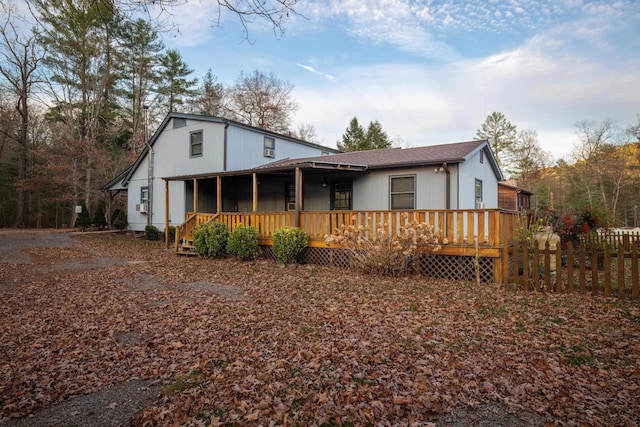 view of front of property with fence and a deck