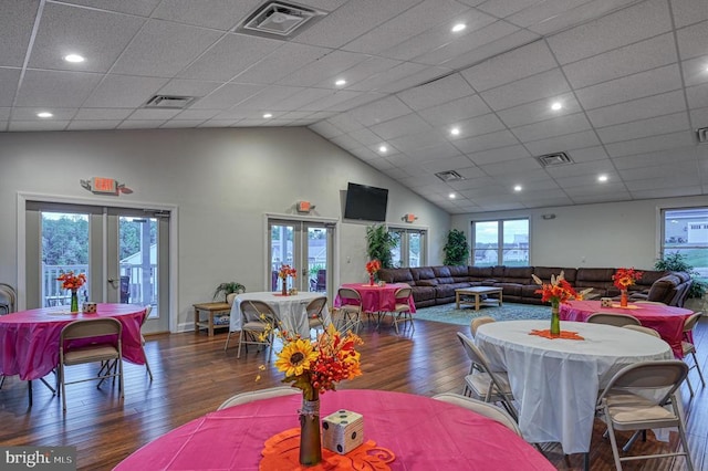 dining area featuring dark hardwood / wood-style floors, high vaulted ceiling, and french doors