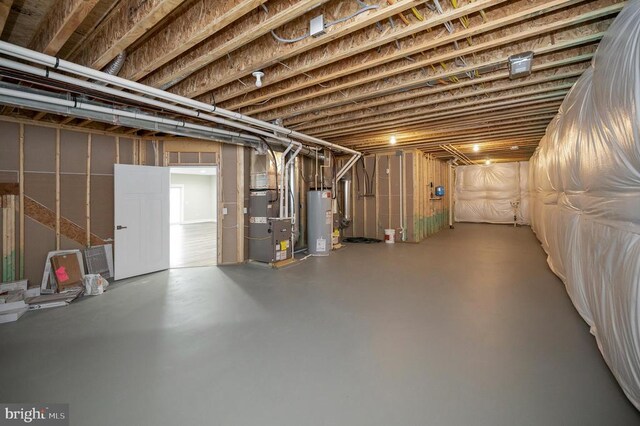 basement featuring heating unit and gas water heater