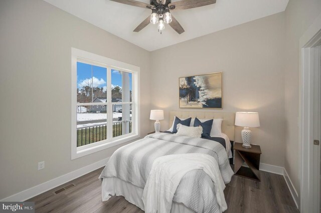 bedroom featuring ceiling fan and dark hardwood / wood-style flooring