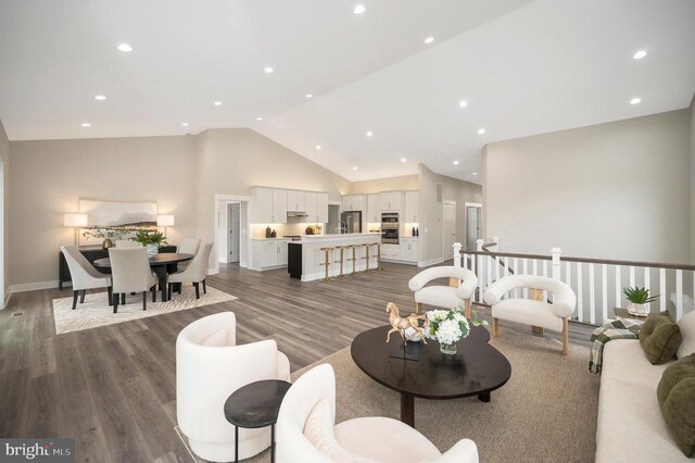 living room with high vaulted ceiling and dark hardwood / wood-style floors