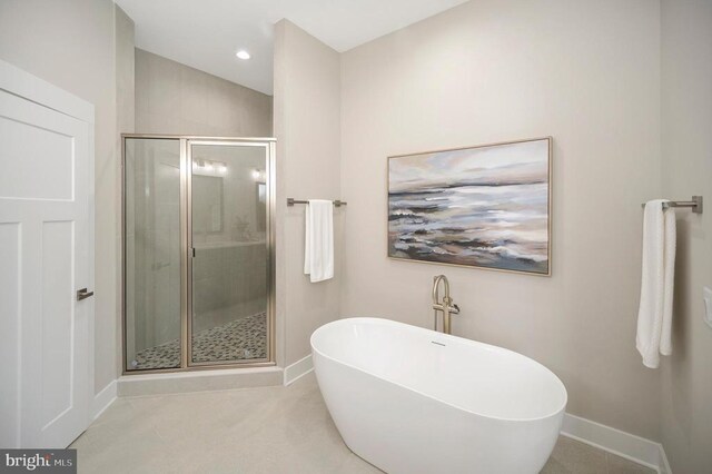 bathroom with shower with separate bathtub