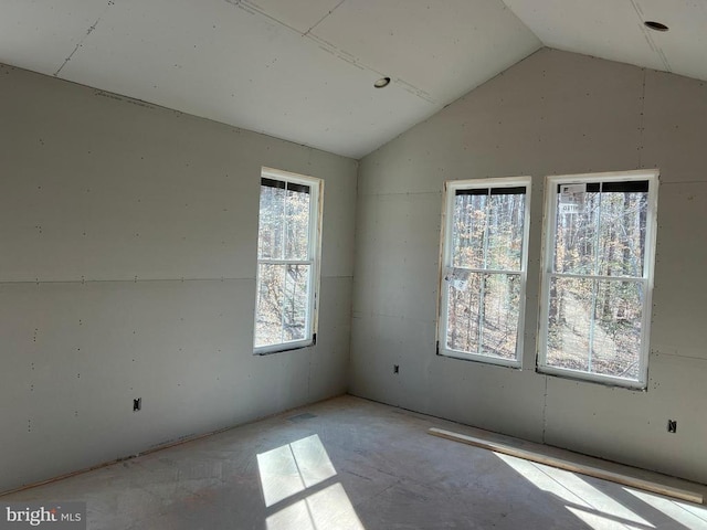 unfurnished room featuring vaulted ceiling