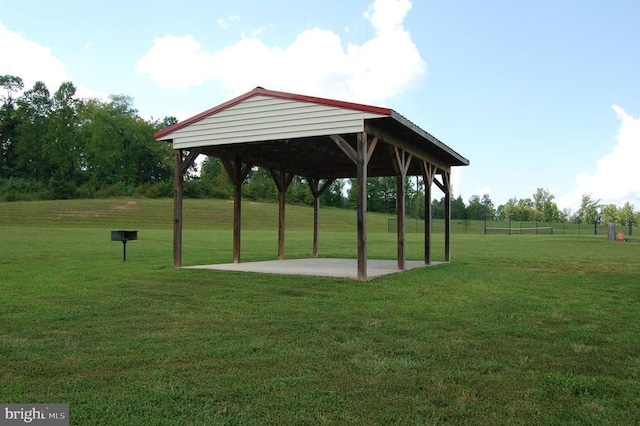 view of property's community featuring a gazebo, a lawn, and a patio