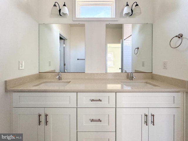 bathroom with a sink and double vanity