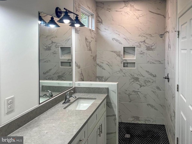 bathroom with vanity and a tile shower