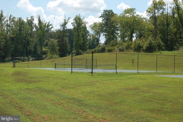 surrounding community with a lawn and fence