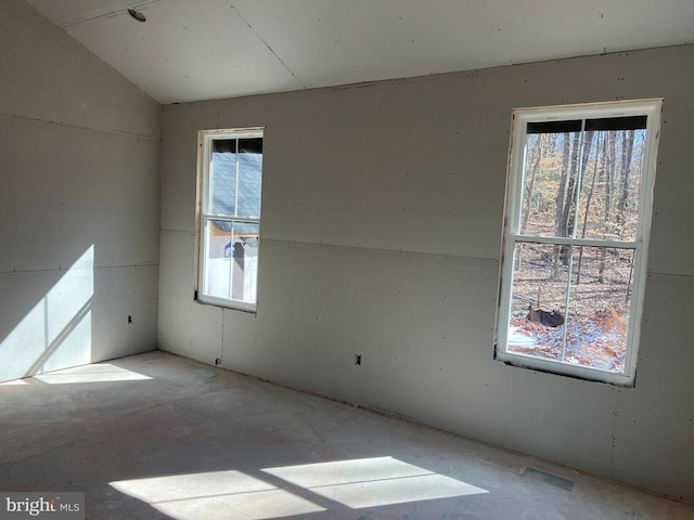 empty room featuring lofted ceiling