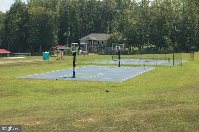 view of basketball court with community basketball court, a yard, and fence