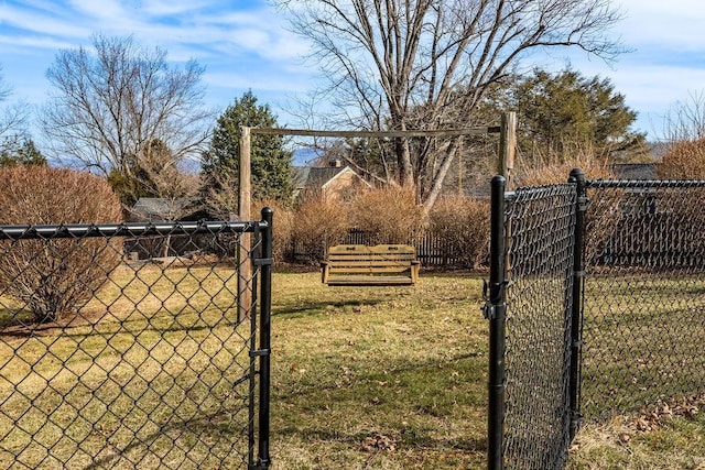 view of gate featuring a yard