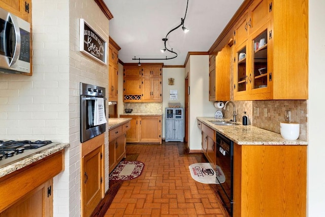 kitchen featuring sink, light stone counters, stainless steel appliances, ornamental molding, and decorative backsplash