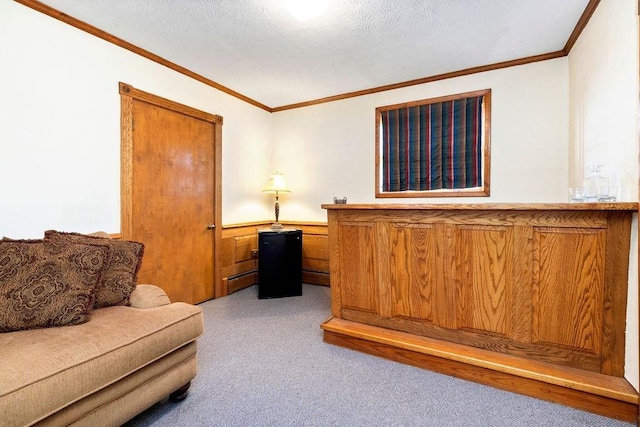 home office with a textured ceiling, crown molding, and light colored carpet