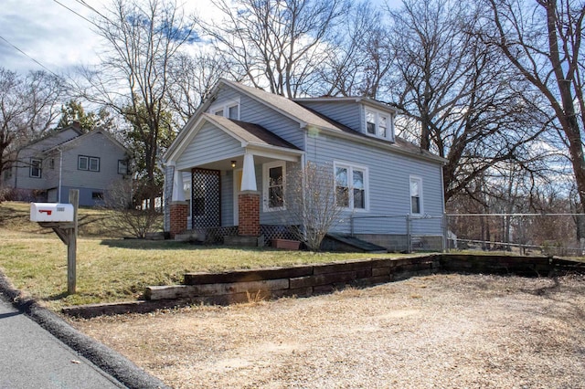 view of front facade with a front lawn and brick siding