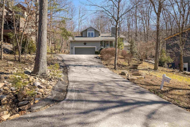 view of front of property with aphalt driveway and a chimney