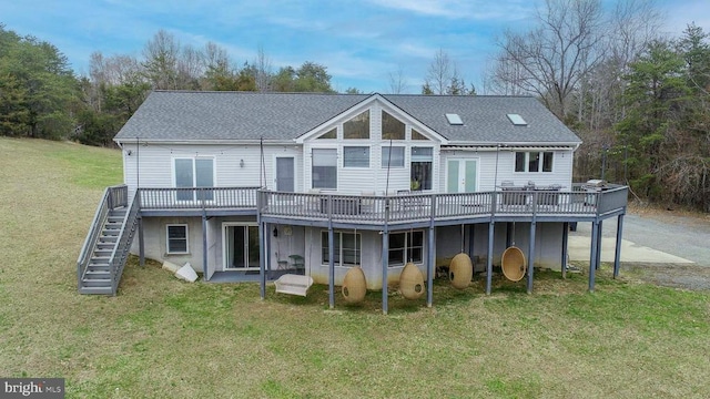 back of house with a yard, a shingled roof, a wooden deck, and stairway