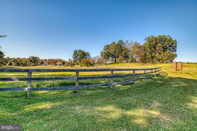 view of yard with a rural view