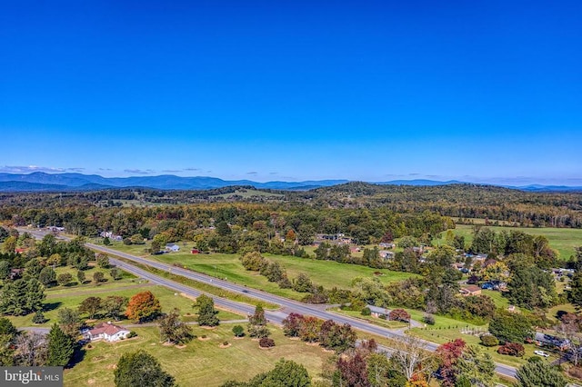 aerial view with a wooded view and a mountain view