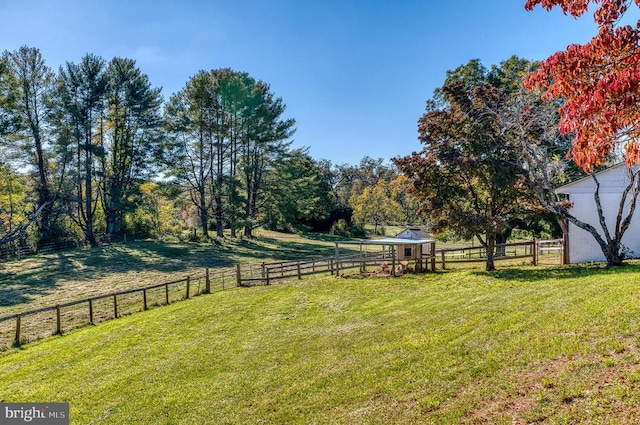 view of yard featuring a rural view and fence