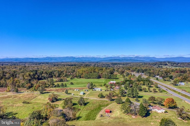 aerial view with a mountain view and a wooded view