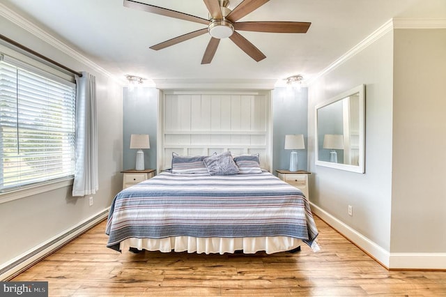 bedroom featuring baseboard heating, ornamental molding, baseboards, and wood finished floors