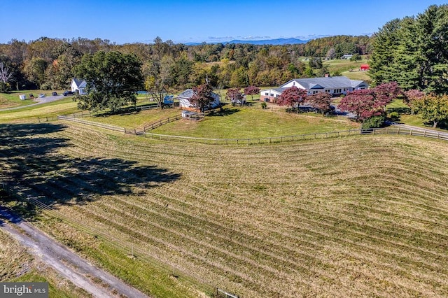 birds eye view of property with a rural view and a wooded view