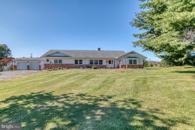 ranch-style home with a garage, driveway, brick siding, and a front yard