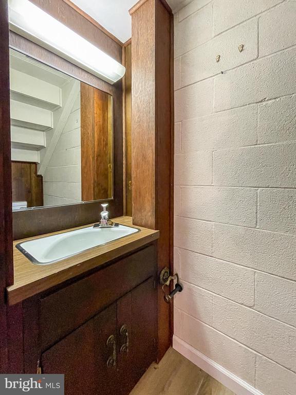 bathroom with vanity and concrete block wall