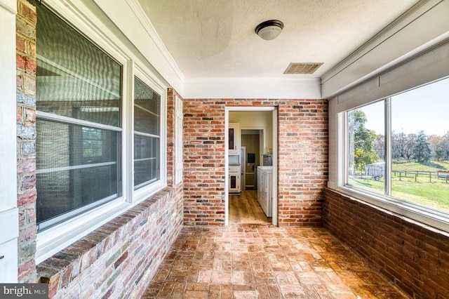 unfurnished sunroom featuring visible vents