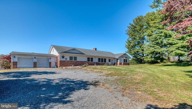 ranch-style home featuring a front yard, brick siding, a garage, and driveway