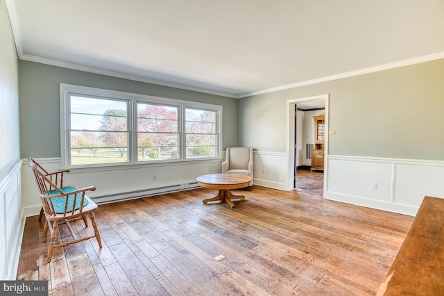 unfurnished room with a baseboard radiator, hardwood / wood-style floors, wainscoting, and crown molding