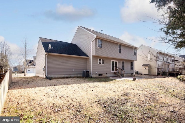 rear view of house featuring fence, central AC, and entry steps