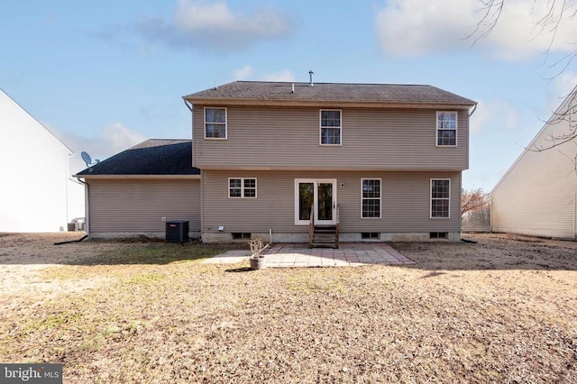 rear view of property with a yard, central air condition unit, entry steps, and a patio