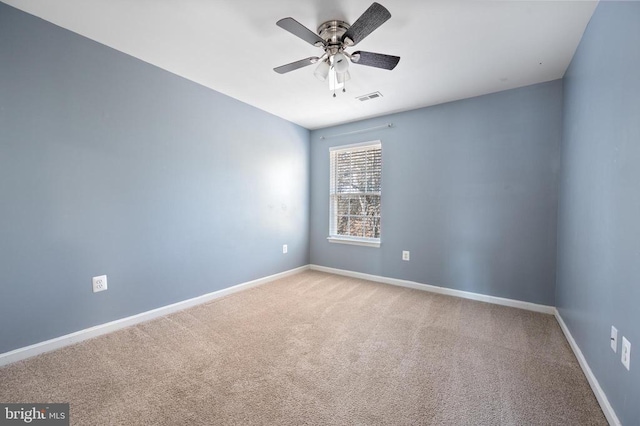 carpeted empty room with a ceiling fan, baseboards, and visible vents