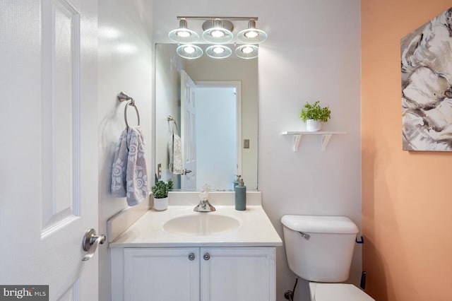 bathroom featuring toilet and vanity