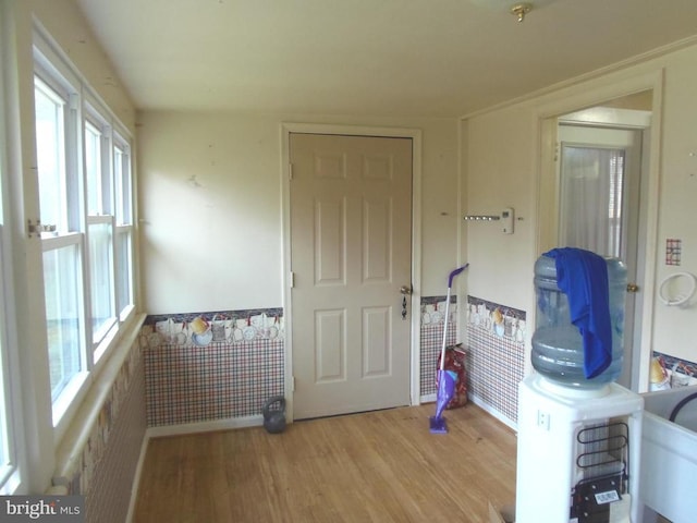 interior space featuring wood finished floors and wainscoting