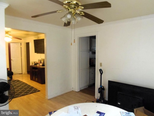 bedroom with wood finished floors, ceiling fan, and ornamental molding