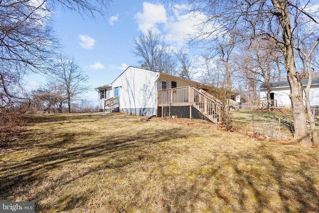 rear view of property with a lawn and fence