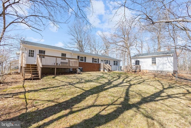 rear view of house with a yard and a wooden deck