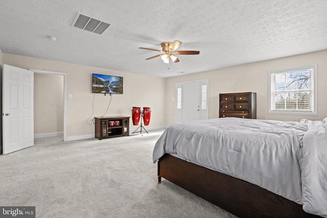 bedroom with baseboards, visible vents, a textured ceiling, and carpet flooring