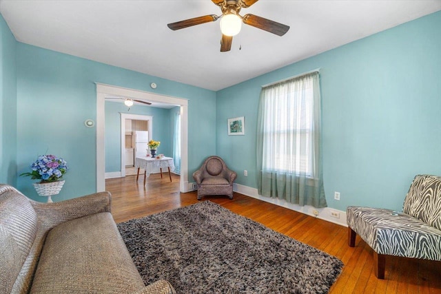 sitting room featuring wood-type flooring and ceiling fan