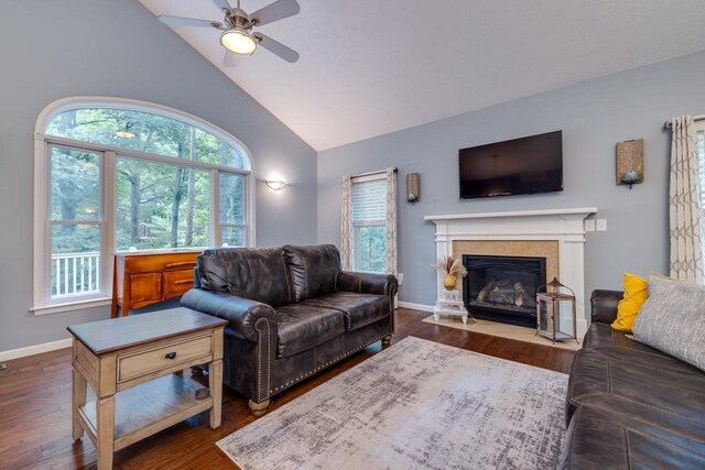 living room with ceiling fan, high vaulted ceiling, and dark hardwood / wood-style flooring