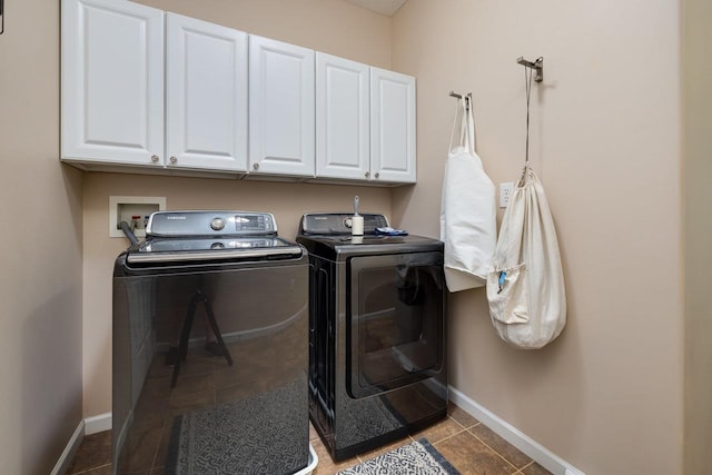 laundry area featuring cabinets, tile patterned flooring, and washer and dryer