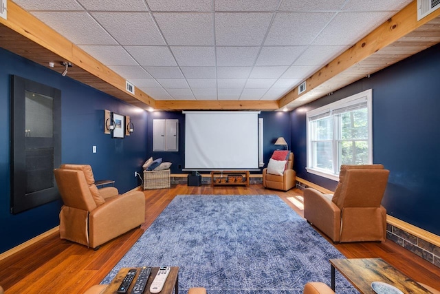 home theater featuring a paneled ceiling and wood-type flooring