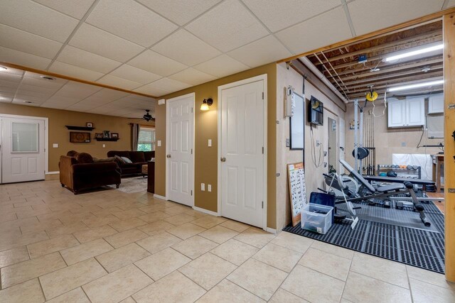 interior space featuring light tile patterned flooring and a paneled ceiling