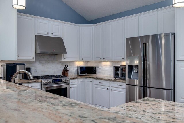 kitchen featuring stainless steel appliances, white cabinetry, and light stone countertops