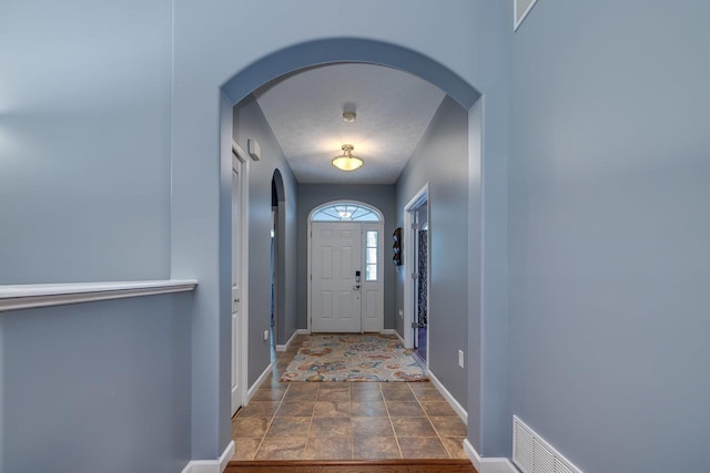 entryway featuring a textured ceiling