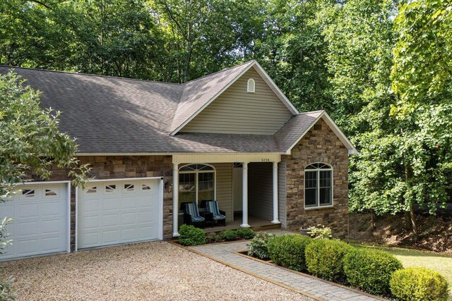 view of property featuring a porch and a garage