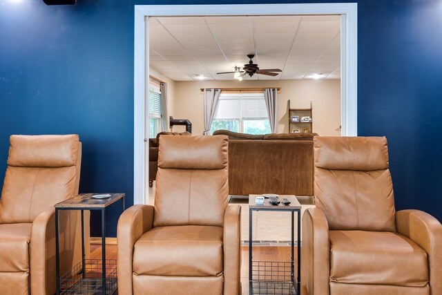 living area with hardwood / wood-style flooring and ceiling fan