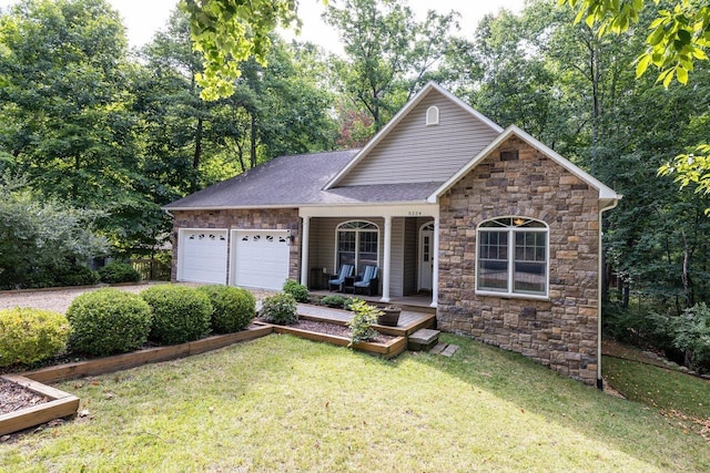 view of front of home featuring a garage, covered porch, and a front lawn