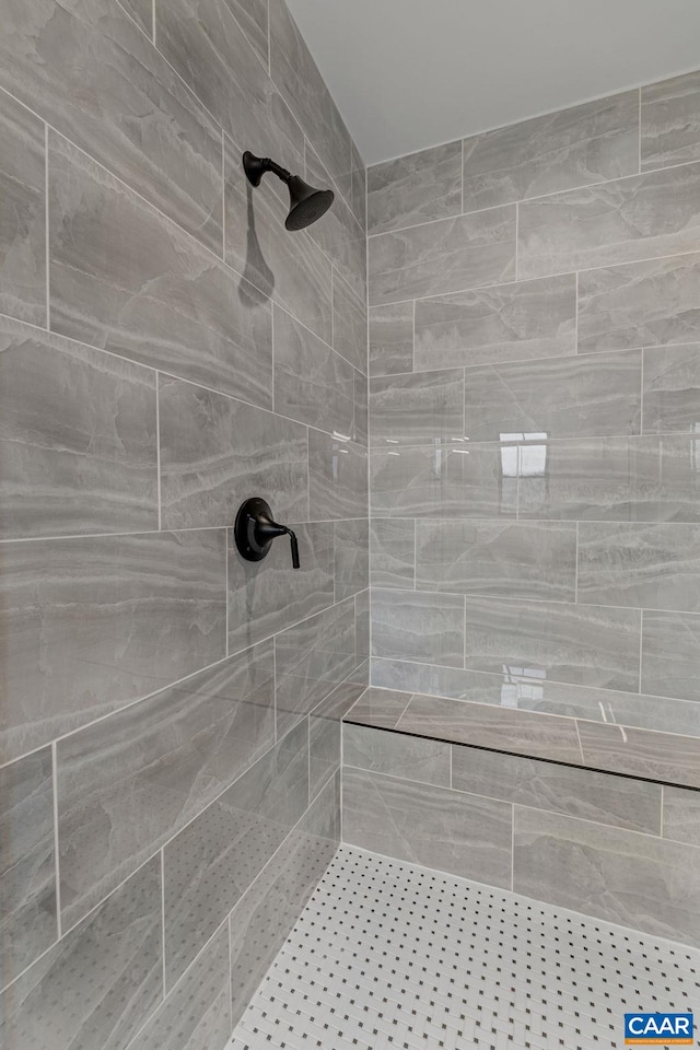 full bath featuring a tile shower